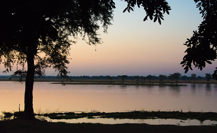 Zambezi Reflections: Sunrise on banks of Zambezi River, Zambia looking towards Zimbabwe on the opposite bank. //Photo: A.N.Grove