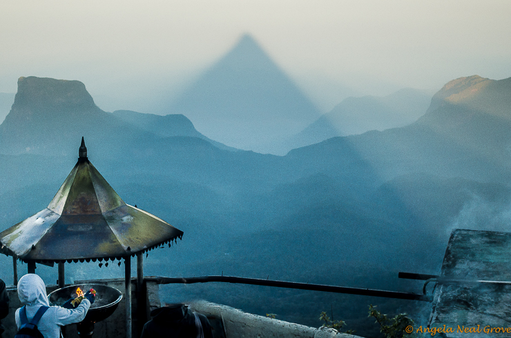 Climbing Adams Peak in Sri Lanka: At sunrise there is the shadow of the mountain which hangs suspended over the valley below