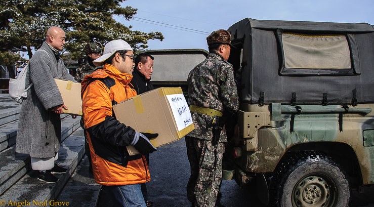 Korea's DMZ Through My Lens: Peacekeepers loading care packages which will be driven across the border to families in North Korea. No one is sure they will reach their destination