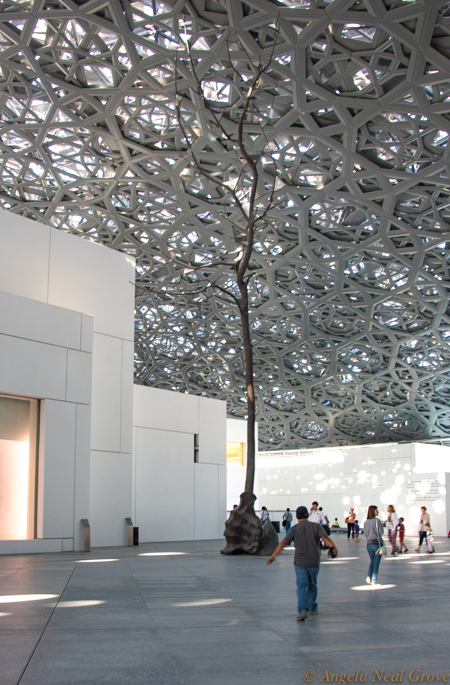 Louvre Abu Dhabi Breaks Boundaries and Bridges Civilizations: Image of inside the dome with soaring tree sculpture by Guiseppe Penone