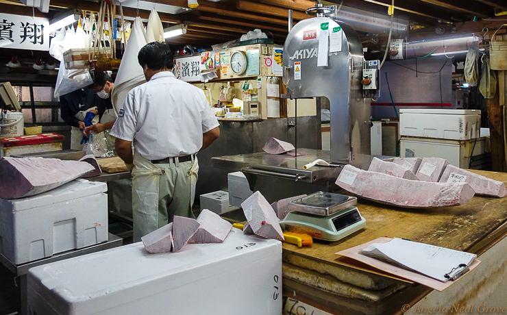 Tokyo Tsukiji Fish Market Going Going Gone...Slicing up frozen tuna after the auction. All tuna is in and out within the day. //Image: A.N. Grove