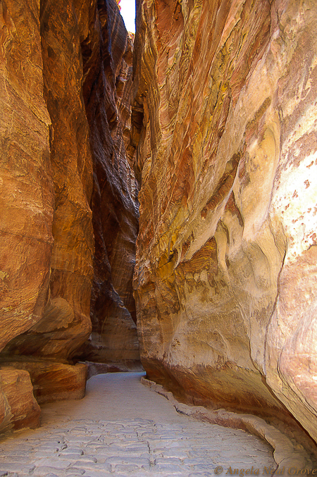 Fabulous Frankincense an Epic Story: This is the entrance to the city of Petra in modern-day Jordan. It was one of the most important ancient trading centers. Location was excellent and it was safe. The only entrance to the city is through a narrow canyon called a Siq. Here the path is paved for camel traffic. On the right is a Nabateen water chanel.//Image: A.N. Grove