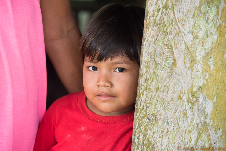 Amazon River Life: Child from the Amazonas Community, Peru, on the Amazon River. They are curious to meet outsiders. PHOTO: ANGROVE