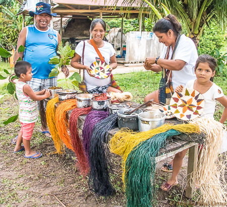 Amazon River Life: NGO Minga Peru has helped teach eco-friendly income generating projects. Here the women show how they dye raffia which they make into beautiful baskets, placemats and other items to tempt the tourist. PHOTO; ANGROVE