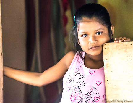 Amazon River Life: This girl in Peru watched as a tour group visited her village. PHOTO; ANGROVE