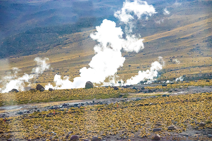 El Tatio Geyser Field, the third largest in the world. Here clouds of steam rises in the early morning. The steam and geysers are created when underground water meets underground rocks heated by volcanoes.