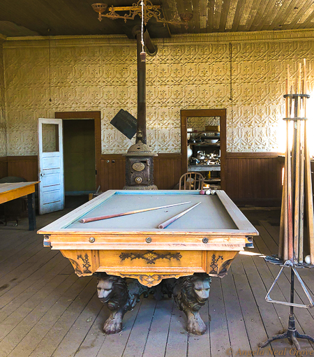 Is Bodie Ghost Town Haunted?Pool table and pot bellied stove in saloon next to general store owned by  Nicholas Luhrs and George Wheaton.  The store was later purchased by James Cain in 1898. The Cain family who owned much of the land eventually sold Bodie to the State of California. Today it is designated as California's official state gold rush ghost town. PHOTO://ANGROVE