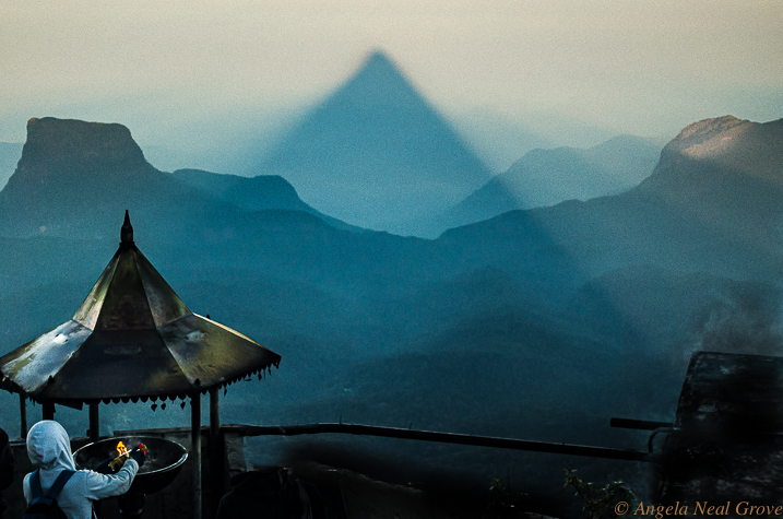 Decade Highlights:  2017 Sunrise Adams Peak Sri Lanka. This phenomenon happens for 30 minutes after sunrise each day. The shadow of Adams Peak is projected across the valley. To reach the peak at 6:00 am we had to begin climbing the mountain with its 5,000 uneven steps at 2:00am.  PHOTO ANGROVE