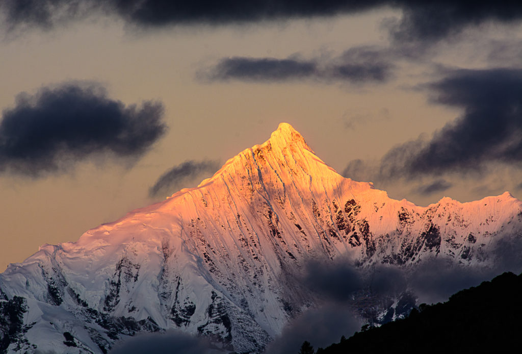 Decade Highlights:  2015 Traveling through Yunnan Province, China we stayed at a Songstam Lodge in Meili. The lodge faces mountains crowned by Mt. Kawagebo which peaks at 22,000 ft. It is sacred and also said to be the inspiration for James Hilton's Lost Horizons. At 5:00 am I was able to capture the first golden light of dawn.  PHOTO: AN GROVE