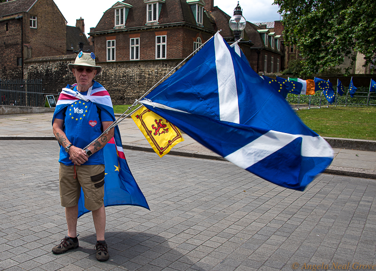 Brexit Ushers A New Era: One of the challenges with the new Brexit Era is whether Scotland will vote to become independent. Will Scotland remain part of the UK? Here is a Scot with Scottish Flags demonsrating outside the Houses of Parliament June 2019. PHOTO: ANGrove