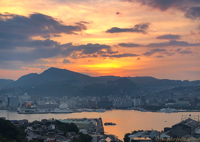 Sunrise over Nagasaki harbor. The force of the Atomic Bomb was contained because Nagasaki is surrounded by hills.  This harbor is now rebuilt and is again thriving. With this new day and sunrise is a prayer for peace  PHOTO; ANGROVE