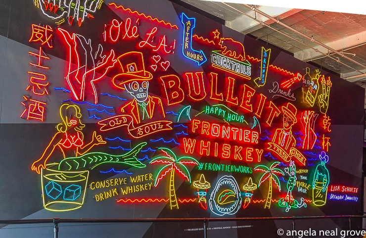 Neon art is making a huge comeback in L.A - huge. From classic signs to contemporary art, neon illuminated L.A. for decades. In 2017 bourbon maker, Bulleit, teamed up with artists Lisa Schulte and Brendan Donnelly to create this 26ft wide neon billboard for the historic Grand Central Market. It has symbolic references to the city's culture.
   // PHOTO: ANGROVE