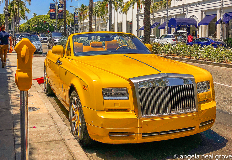 Yellow Rolls Royce parked on Rodeo Drive, Beverly Hills. Post-pandemic foot traffic has returned to this street famous for exclusive shops.  Shoppers are again piling tote bags from luxury store into waiting cars. The people watching is fun.
 // PHOTO: ANGROVE