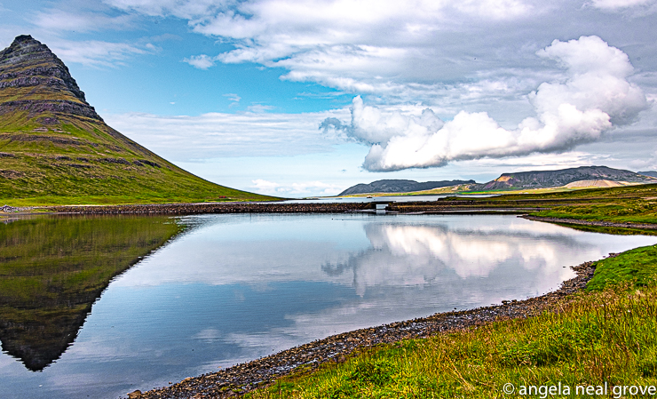 Near Grundafjordur small fishing town is this old volcanic cone, Kirjufell, which is reflected in the pool of water.  Iceland is a land of contrasts. //: PHOTO: A.N GROVE