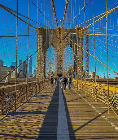 Walking the Brooklyn Bridge in November sunshine. Unusually warm weather for this late fall walk.  To the left is the Freedom Tower  PHOTO;// ANGROVE