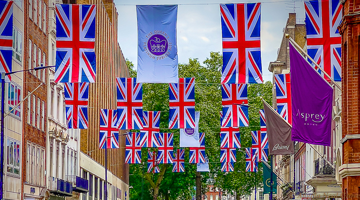 Happy and Glorious Platinum Jubilee. London awash with flags to celebrate the Happy and Glorious Platinum Jubilee of Queen Elizabeth II.  This cluster of  Union flage hang between Bond Street and Berkeley Square, London. Photo: ANGROVE