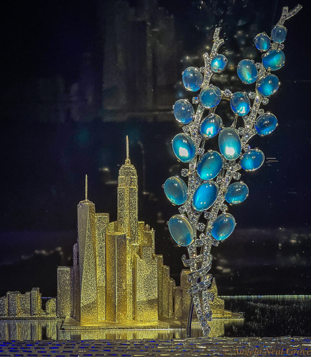 Glittering summer season in London:  Window display from flagship store on Fifth Avenue. This was inspired by Truman Capote who once described New York as "a diamond iceberg floating on river water." This design evokes Manhattan with Capote's diamond iceberg, a moonstone brooch, adorning its skyscrapers   PHOTO: //ANGROVE