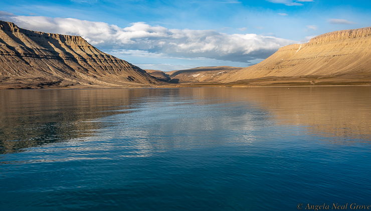 Northwest Passage Arctic Adventure: Fijords of Devon Island with towering cliffs of sedimentary sandstone. Devon Island is high dry desert which some have likened to Mars.  //PHOTO ANGROVE