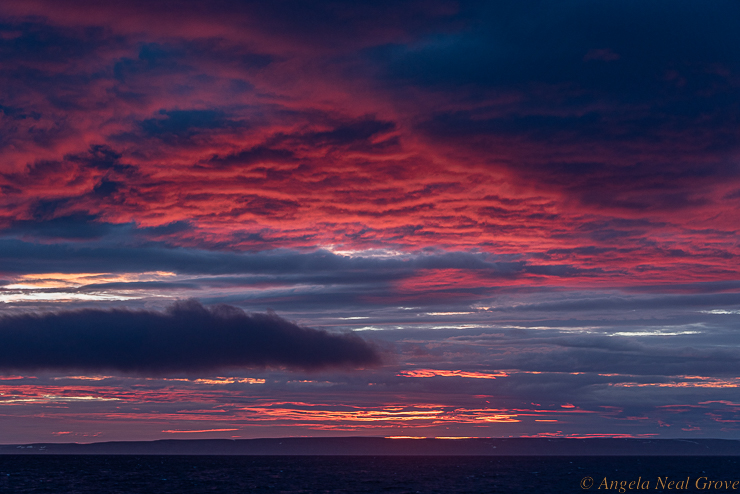 Northwest passage Arctic Adventure: When we boarded the yacht on August 12 there was no sunset/sunrise, just one long day.  Twelve days later there was already a two hour gap.  (Winter comes quickly and is totally dark). I photographed this sunrise at 3:15.  It was one of the most incredible things I have ever seen.  Even this image does not do it justice.  I have not processed this in any way.  The color is exactly what I saw. No filter.  //PHOTO ANGROVE