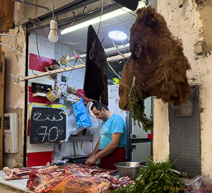 Fez, Morocco. Butcher selling camel meat in the Medina.  There is a camel head hanging on the wall  //PHOTO: ANGROVE