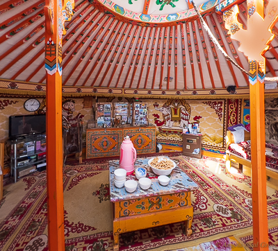 Inside the camel herder's ger. It was decorated with traditional painting wall coverings and rugs. There were also modern conveniences, including a TV and fridge //Photo: ANGrove