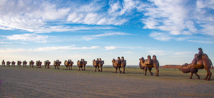 
The Great Tea Route, was an ancient trade corridor from China to Russia. It stretched over 8,900 miles crossing the Gobi desert and steppe. A major stop was UlaanBaator, then called Ikh Khuree. The caravan of camels carrying compressed tea in bricks were bound for Saint Petersburg. These bronze camels near the Flaming Cliffs commemorate the journey.//Photo: ANGrove