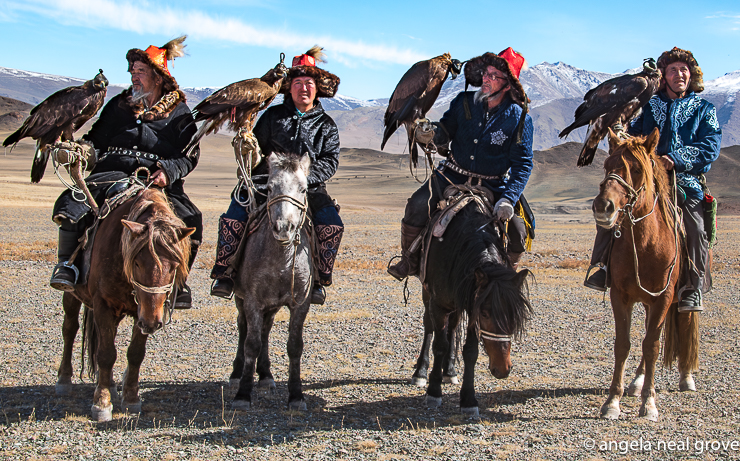 Four Kazakh hunters on horseback with their eagles. They pause before a hunt for fox at the base of a mountain in Western Mongolia's Bayan-Ulgii province. For more than two millennia Kazak men have hunted on horseback with trained golden eagles.  :// Photo A N Grove