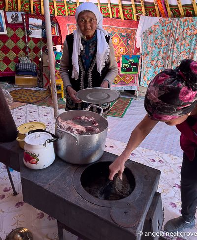 Preparing to cook a sheep with carrots and potatoes for lunch in a Kazakh Ger.  The stove in the Ger has a flue which exits through the roof. Photo://AN Grove