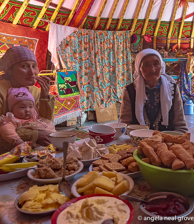 Inside a Kazakh ger in Western Mongolia. Tables are piled with bowls of traditional fried dough and plates of sweets. Photo://ANGrove